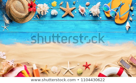 beach-accessories-on-blue-plank-450w-1104430622.jpg